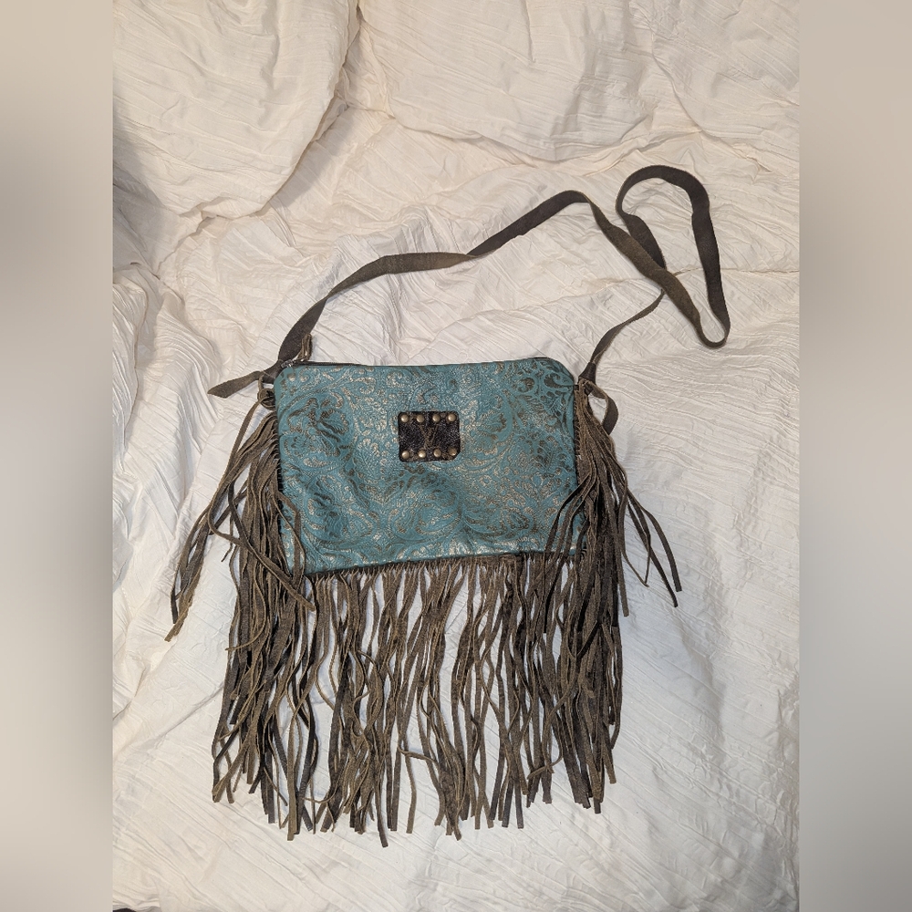 Tooled bag with authentic Louis Vuitton patch and fringe